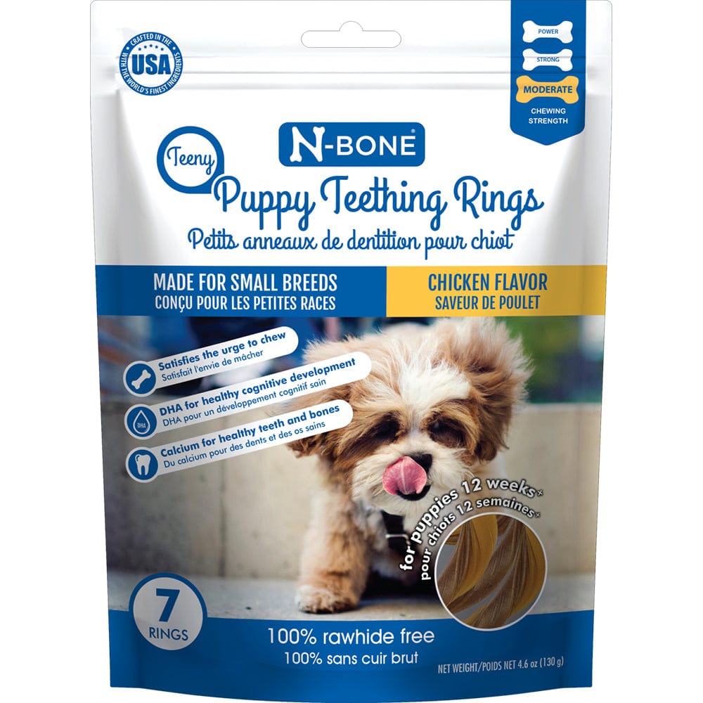 Package of N-Bone Puppy Teething Rings with a small dog's face on the front, indicating it's for small breeds and has a chicken flavor. It highlights being 100% raw, free from corn, dairy, soy, and wheat, and being easy for pets to hold.