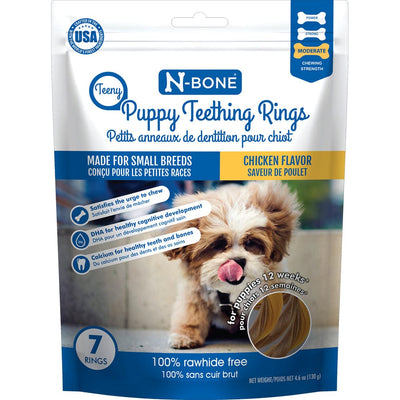 Package of N-Bone Puppy Teething Rings with a small dog's face on the front, indicating it's for small breeds and has a chicken flavor. It highlights being 100% raw, free from corn, dairy, soy, and wheat, and being easy for pets to hold.