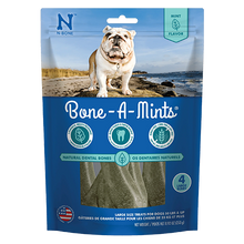 N-Bone Bone-A-Mints dog treat package with a dog on a beach